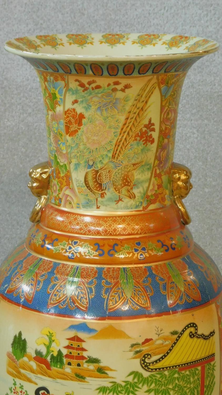 A large ceramic painted and transfer design Oriental vase with gilded lion's head ring handles. - Image 2 of 8