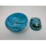 An Egyptian style turquoise glazed frog paperweight with heiroglyphs to the base along with a dyed