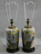 A pair of Chinese style table lamps of fluted baluster form in decorative floral glaze resting on