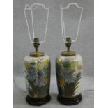 A pair of Chinese style table lamps of fluted baluster form in decorative floral glaze resting on