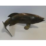 A Chinese stylised brass cast figure of a carp swimming. H.26xW.60cm