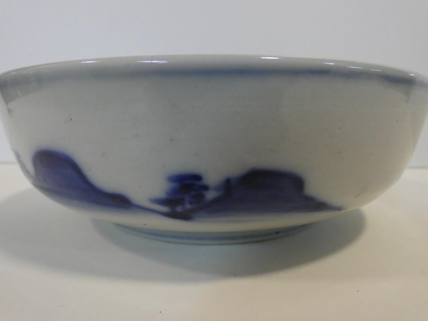 A Meji period blue and white ceramic Japanese bowl with hand painted village scene with mountains in - Image 7 of 8