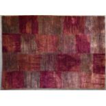 A contemporary rug with abstract chequerboard design in shades of plum. L.244x175cm