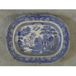 A large antique Staffordshire stoneware blue and white willow pattern transferware design meat