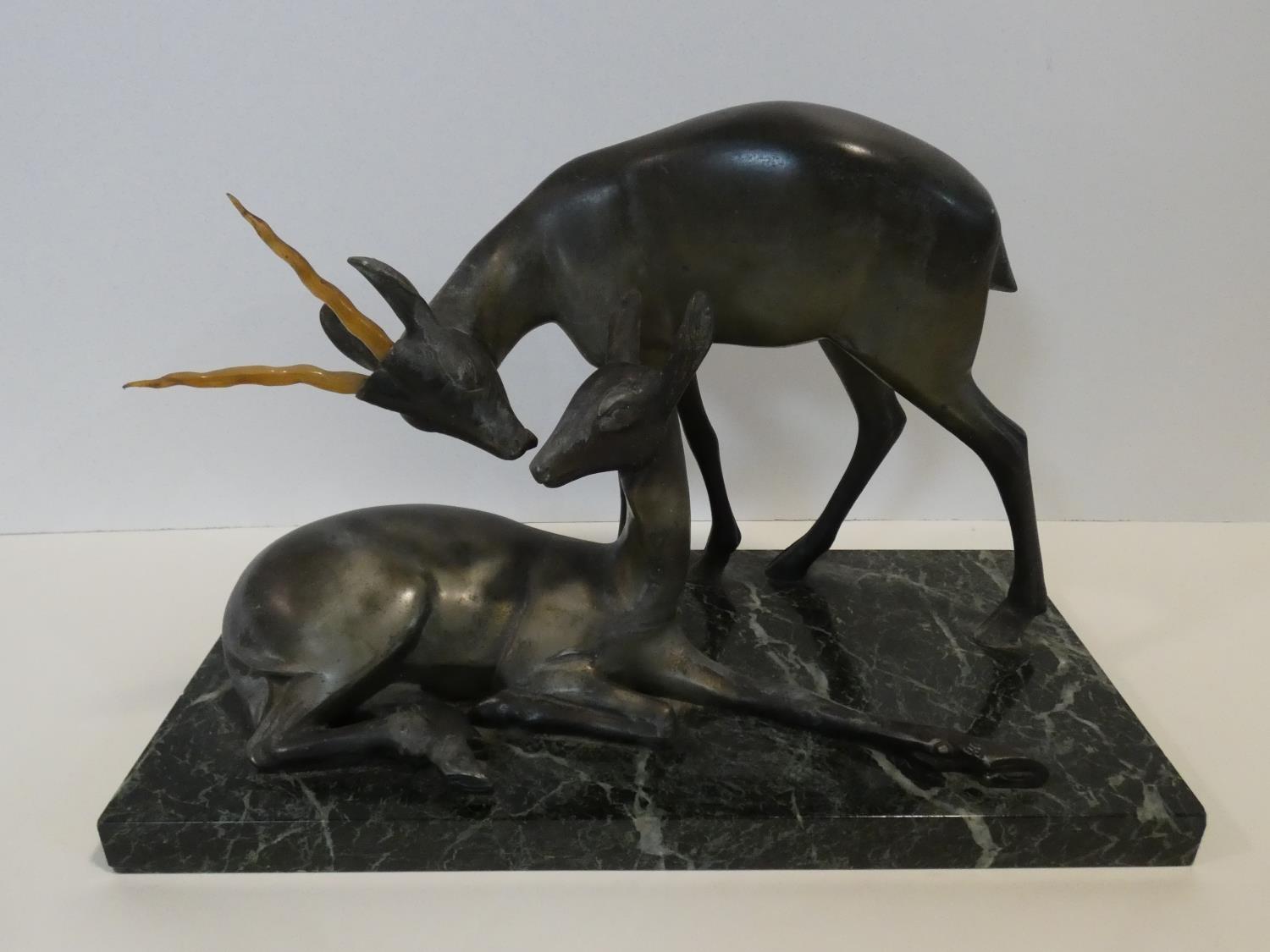 A pair of spelter Art Deco male and female gazelles mounted on a black and white veined marble base. - Image 2 of 7