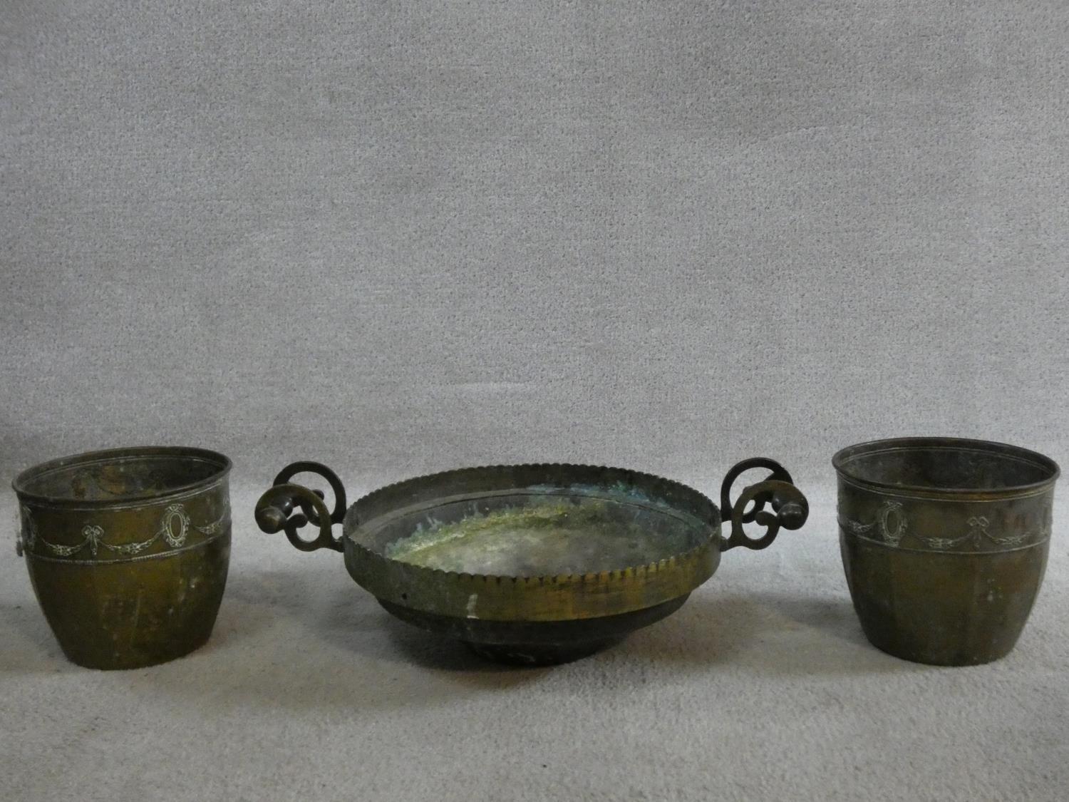 A pair of brass jardinieres with Adam style husk and ribbon decoration and a brass twin handled