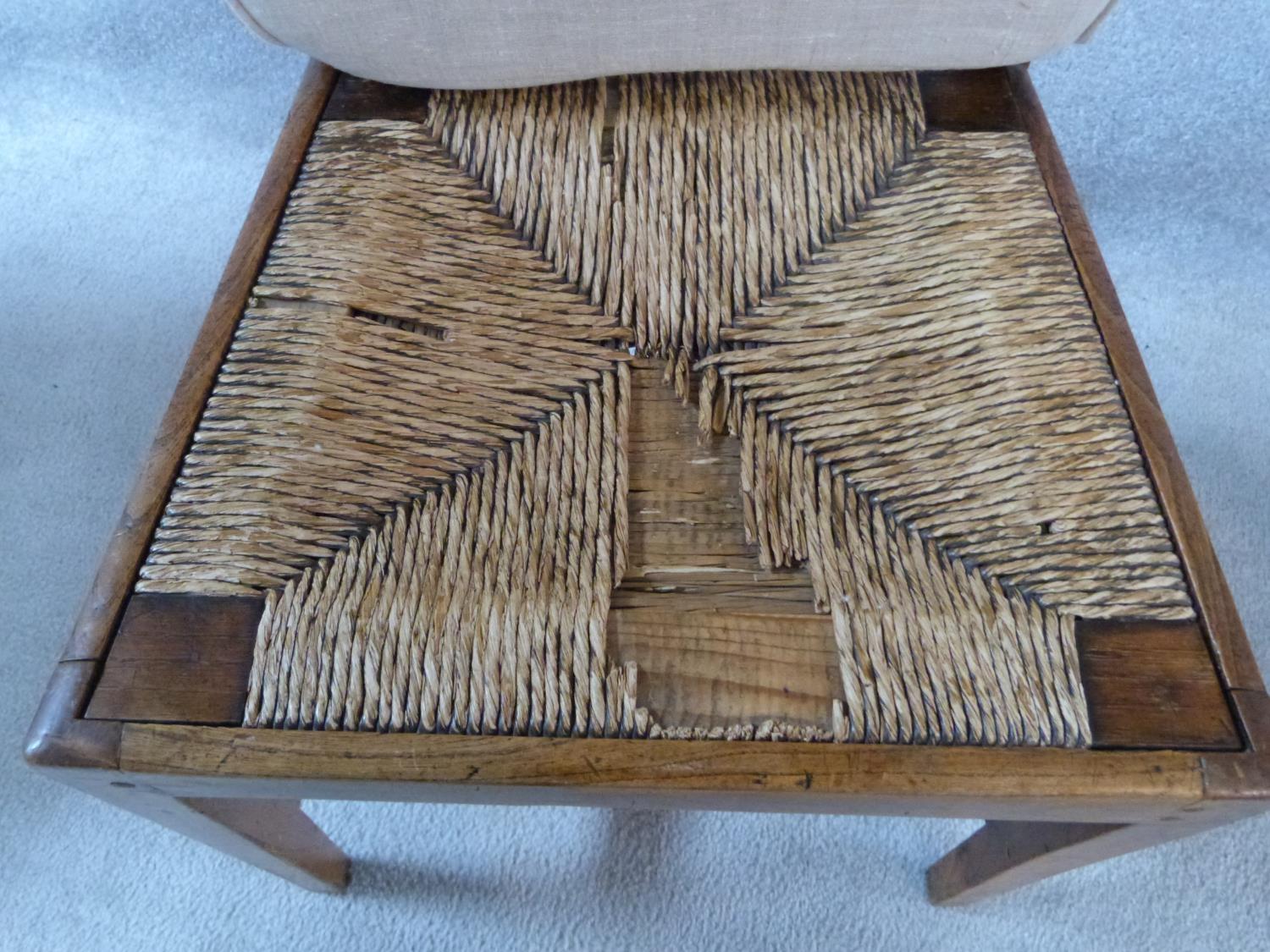 A set of four antique country elm dining chairs with carved rail backs and rush drop in seats. Three - Image 5 of 8