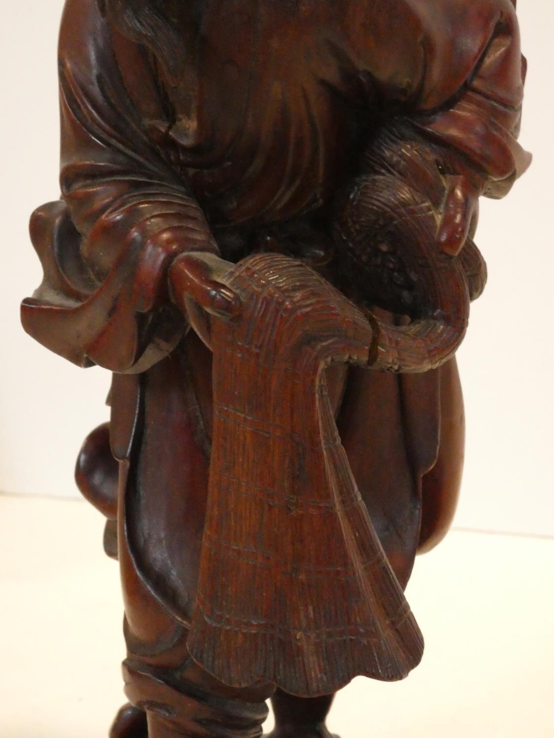 A collection of Chinese figures and masks. Including a resin wood effect mask, a carved wooden - Image 4 of 14