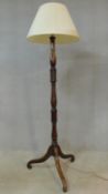 An early 20th century mahogany standard lamp with turned column on tripod cabriole supports. H.184cm