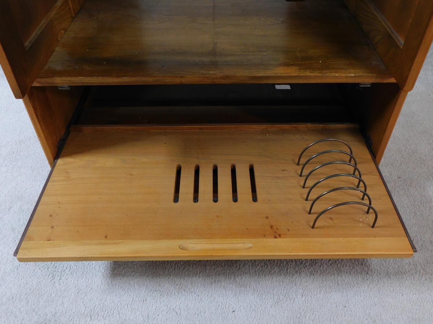 A vintage elm Ercol cabinet with panel doors and drop down base door fitted for HI Fi. H.94xW.85xL. - Image 5 of 13