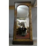 A mid Victorian burr elm veneered narrow linen press with arched glazed door enclosing shelves and