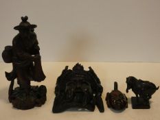 A collection of Chinese figures and masks. Including a resin wood effect mask, a carved wooden