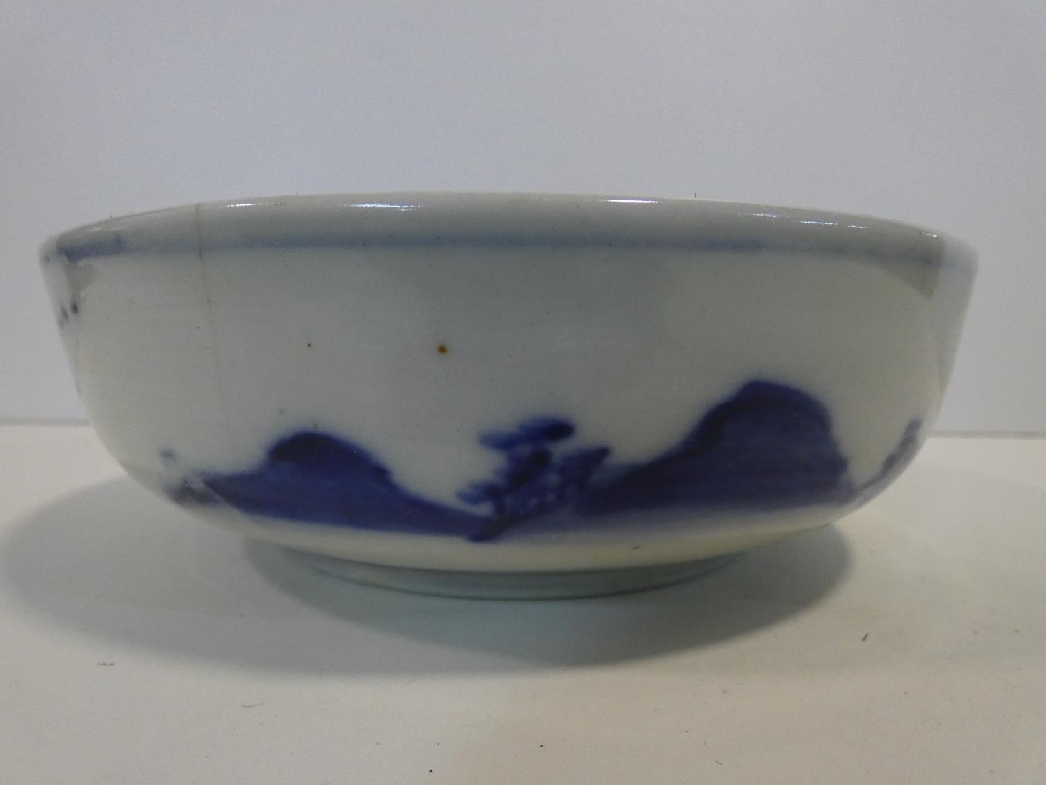 A Meji period blue and white ceramic Japanese bowl with hand painted village scene with mountains in - Image 4 of 8
