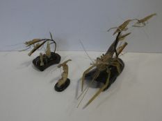A 20th century Chinese carved horn figure group of prawns underwater in a naturalistic setting on