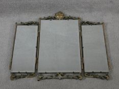 A mid century vintage triple section dressing mirror with painted and carved scrolling foliate frame