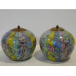 A pair of 20th century Chinese wooden lidded colourful glaze jars with flowers, birds and insects.