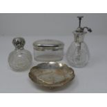 A collection of silver items. Including a silver topped scent bottle, silver flower form trinket