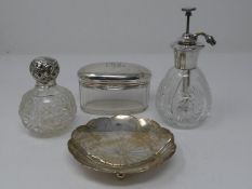 A collection of silver items. Including a silver topped scent bottle, silver flower form trinket