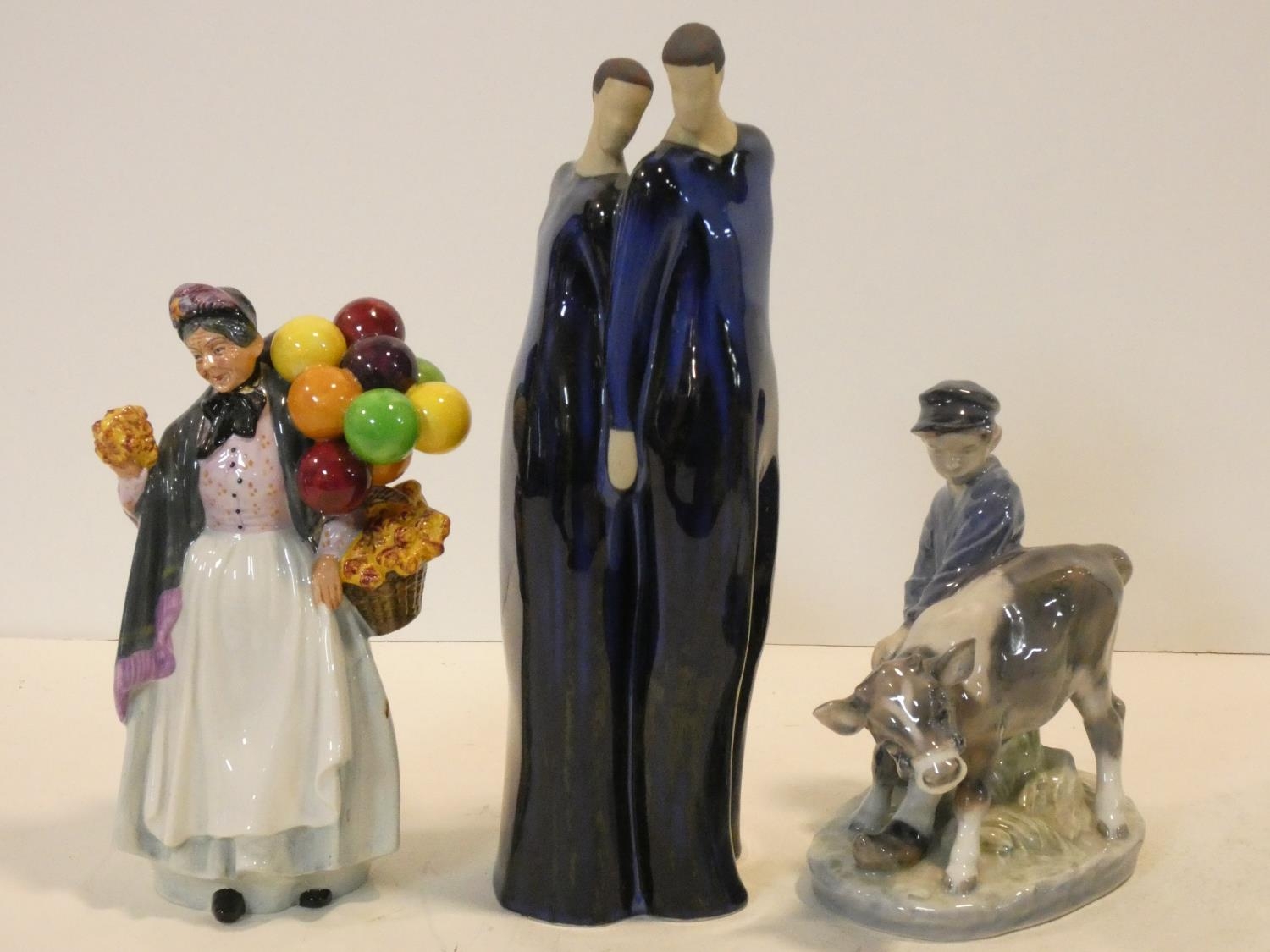 A Royal Doulton figure, balloon seller, a JIE Danish ceramik figure group of a couple standing close