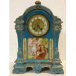A 19th century ceramic cased mantel clock in pale blue glaze and gilt highlights, enamel and gilt