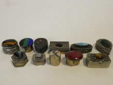 A miscellaneous collection of eleven miniature lidded cases and pill boxes to include, white metal