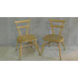 A pair of vintage Ercol child's chairs in blonde beech and elm on turned stretchered supports. H.