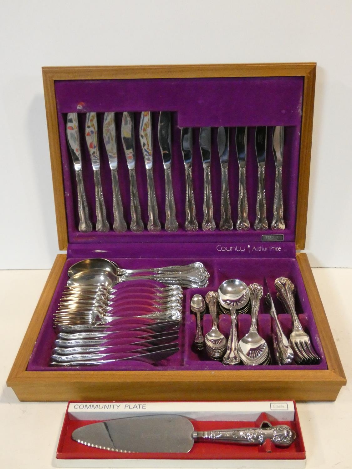 A cased Arthur Price County silver pate canteen with repousse design along with a silver plated cake