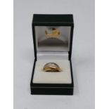A yellow, red and white metal Russian wedding band. Faint engraving. Ring size K. Weight 5.9g.