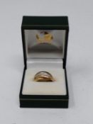 A yellow, red and white metal Russian wedding band. Faint engraving. Ring size K. Weight 5.9g.