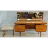 A mid century vintage teak G-Plan dressing table with its matching stool with faux lambswool seat.