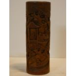 A Chinese bamboo brush pot with carved decoration depicting village scenes. H.32cm