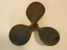 A vintage solid brass three blade boat propellor. 23x23cm