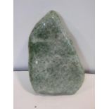 A large polished green stone crystal boulder. L.31cm