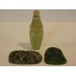 A Chinese carved jade lidded urn with flower finial and articulated ring handles and animal