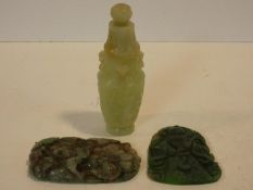 A Chinese carved jade lidded urn with flower finial and articulated ring handles and animal
