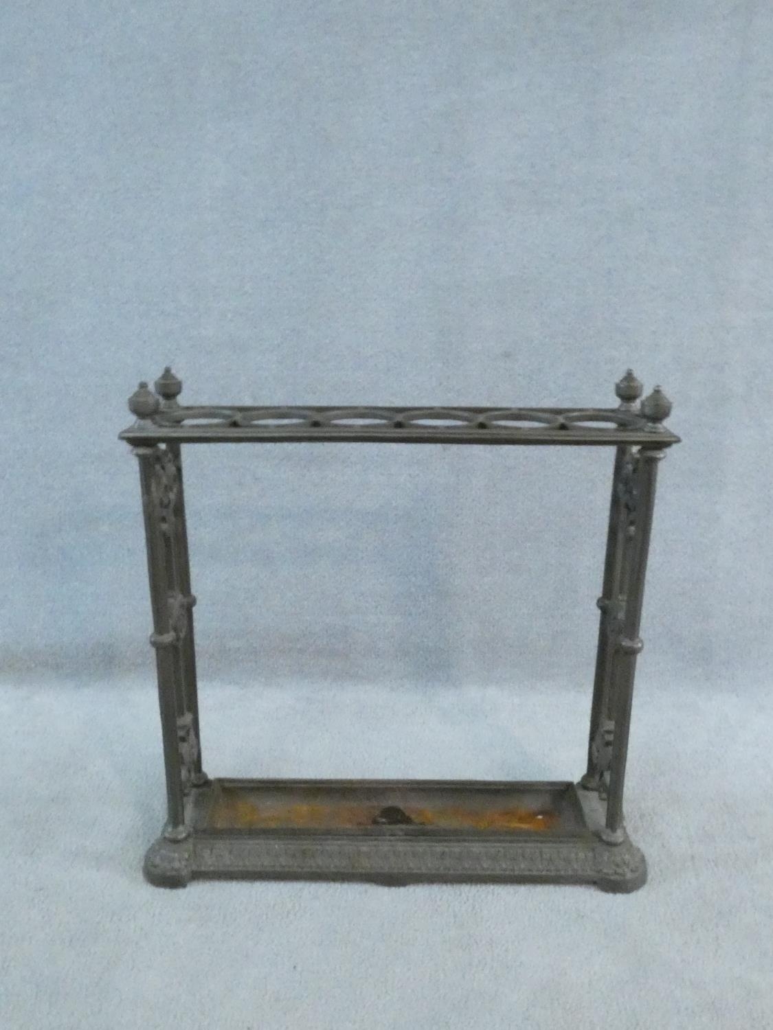 A late 19th century Coalbrookedale style umbrella and stick stand with lift out drip tray. H.62 W.62