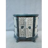 A 19th century wrought iron stove case with pierced panels and and pair of doors each with central