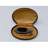 A cased Art Deco German marcasite and onyx metamorphic lorgnette/brooch with geometric design,