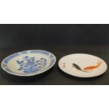 Two antique hand painted Oriental ceramic plates. One with a blue and white floral design with a