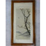 An early 20th century framed and glazed Japanese silk embroidery, a bird in flight with blossom on