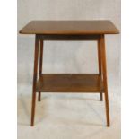 An Edwardian mahogany occasional table with splayed square tapering supports united by undertier.