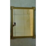 An early 20th century painted wall mirror with gilt egg and dart moulded frame. 70x53cm
