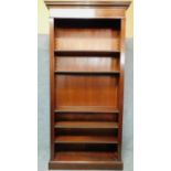 An Edwardian style mahogany floor standing open library bookcase with dentil cornice and satinwood