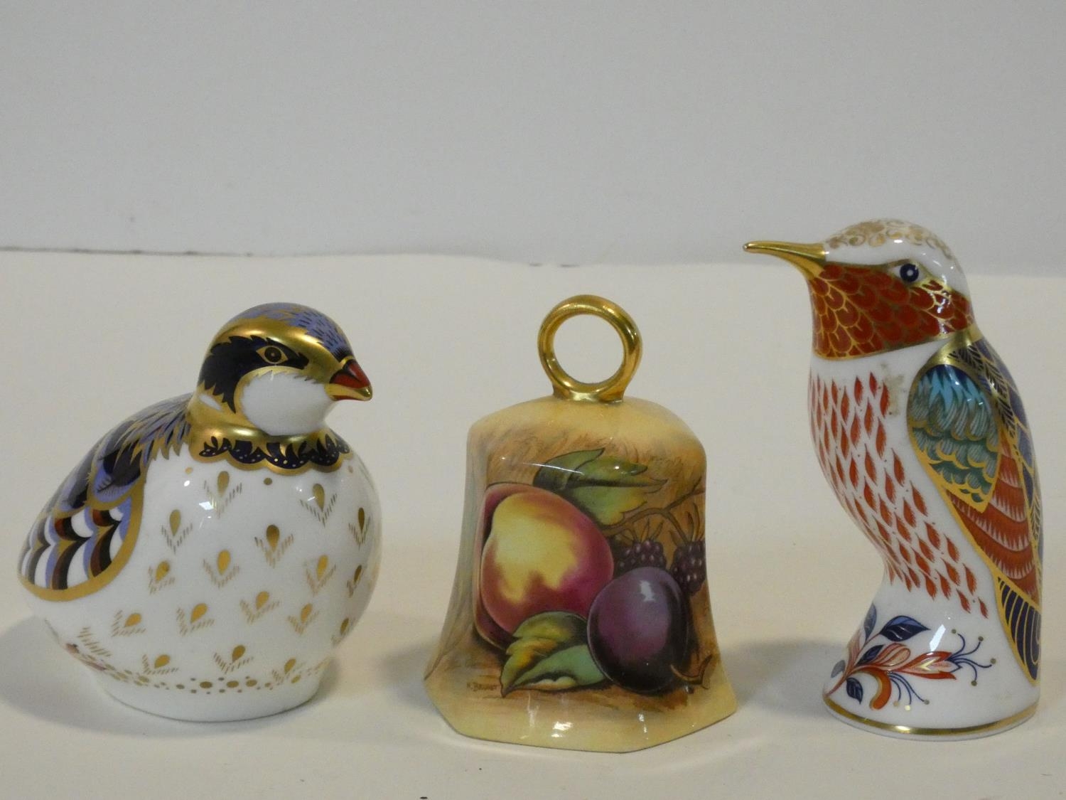A collection of porcelain items. Including an Aynsley Orchard Gold fruit design hand bell along with