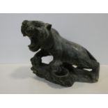 A Chinese carved greenstone figure of a prowling growling tiger on a naturalistic base. H.31xW.35cm
