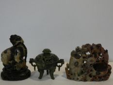 A Chinese carved soapstone lidded censer, a soapstone Dog of Fo on carved wooden base and a