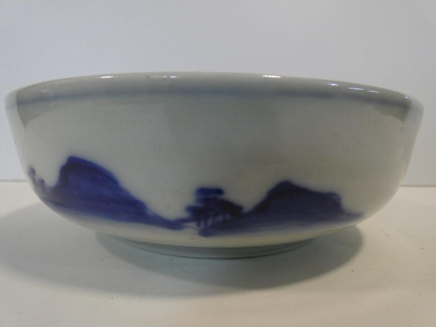 A Meji period blue and white ceramic Japanese bowl with hand painted village scene with mountains in - Image 5 of 8