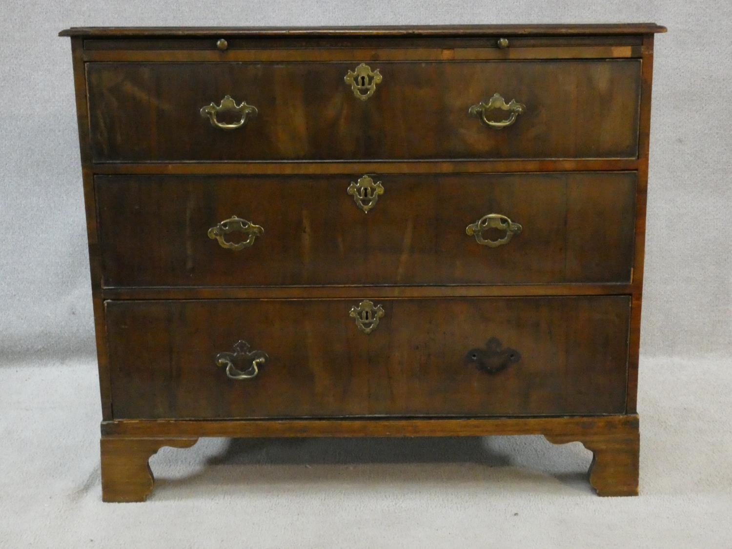 A Georgian walnut chest of three long drawers fitted with brushing slide raised on ogee bracket - Image 2 of 6