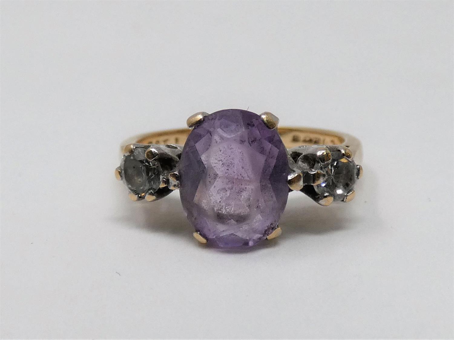 A 9ct yellow gold and white metal three stone ring, set with purple and white paste stones. Shank - Image 6 of 6