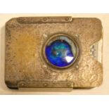 A Liberty Tudric style hammered pewter playing card case with iridescent blue enamel central roundel